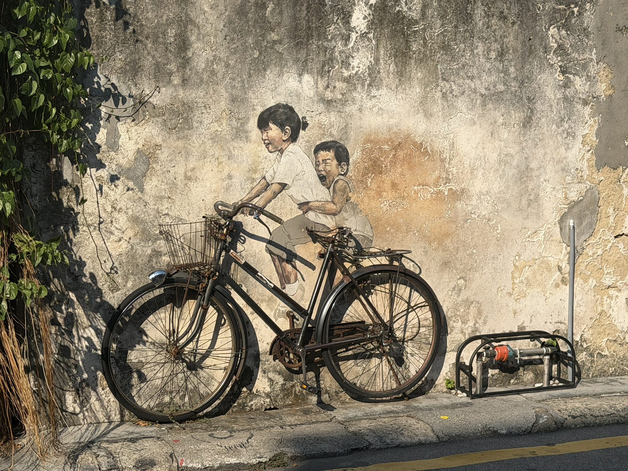 Penang famous street art 'Little Children on a Bicycle' on Armenian Street in George Town.