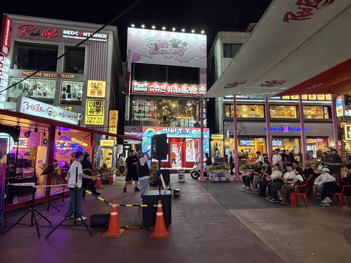 Street performer entertaining a crowd in Hongdae at night