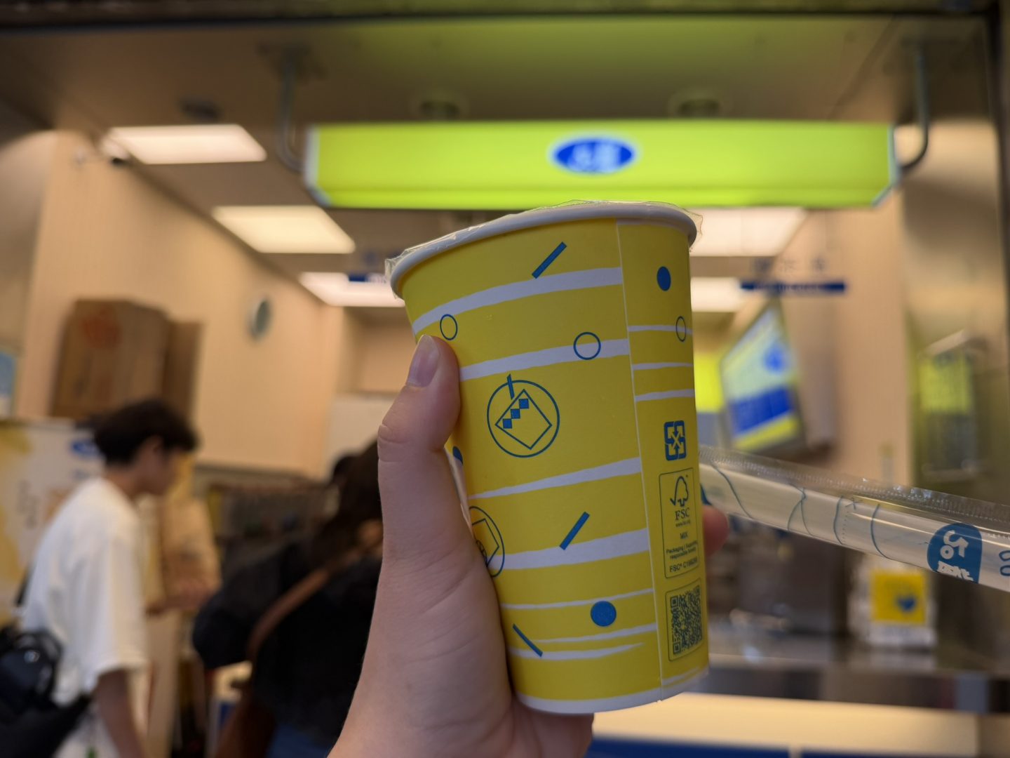 Yellow 50 Lan bubble tea cup held inside a Taiwan branch