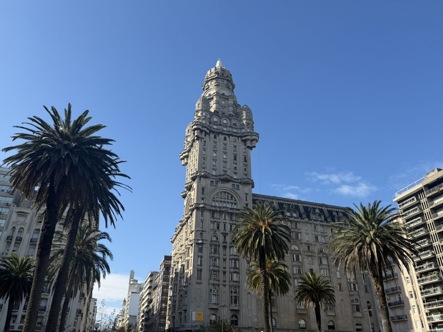 Historic tower and palm tree in central Montevideo