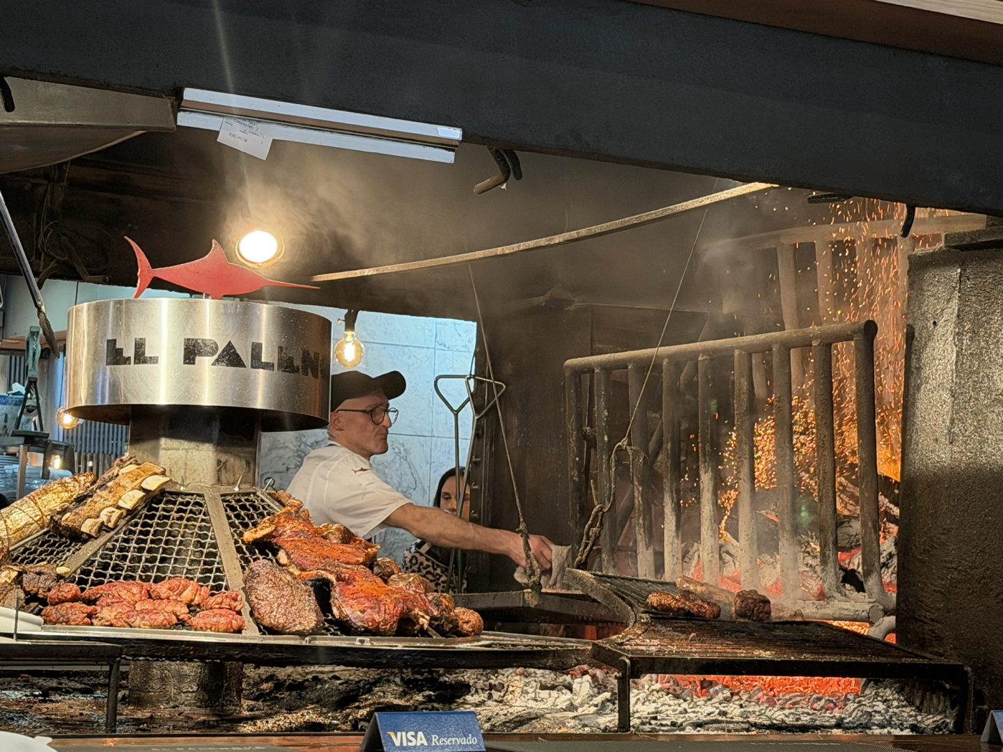 Meat cooking over a traditional parrilla grill in Montevideo